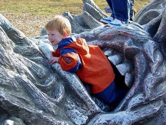 Child climbing out of the mouth of "The Awakening"