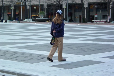 Woman walking across Freedom Plaza