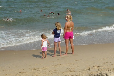 Three people at the water's edge