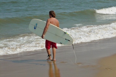 Man carrying a surfboard