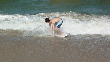 Teen surfing on a small wave