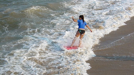 Woman surfing at Virginia Beach