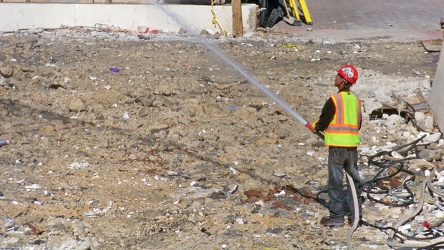 Man holding hose during demolition work [03]