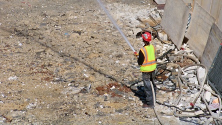 Man holding hose during demolition work [02]