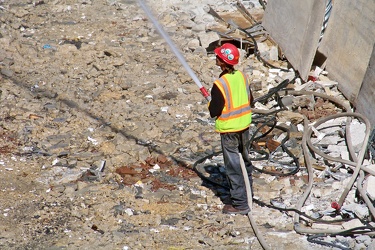 Man holding hose during demolition work [01]