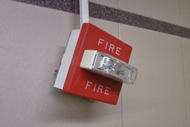 Fire alarm hanging by conduit