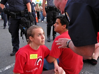 Police officer speaking to demonstrator during civil disobedience action