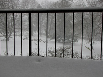 Snow on an apartment balcony during Snowpocalypse storm