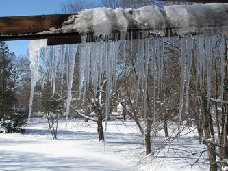 Damaged gutter system hanging from building [03]