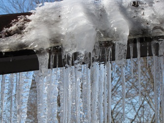 Damaged gutter system hanging from building [04]