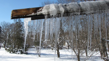 Damaged gutter system hanging from building [05]