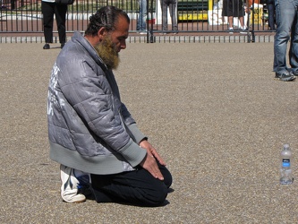 Man praying on Pennsylvania Avenue NW [03]