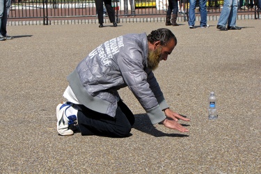 Man praying on Pennsylvania Avenue NW [01]