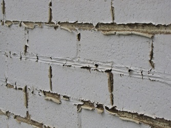 Peeling paint on brick