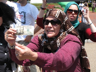 Woman holds $20 bill during anti-Gaddafi protest