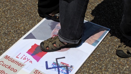 Stepping on photo of Muammar Gaddafi