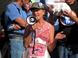 Woman speaking at Stop the Machine demonstration