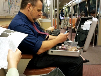 Man with open briefcase on the Metro