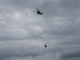 Helicopter delivering a rooftop HVAC unit [02]