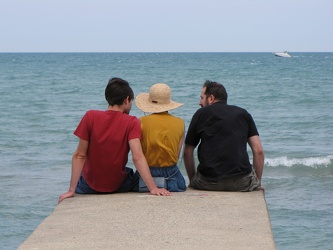 Three people on a pier