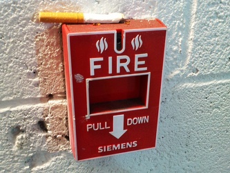 Cigarette on fire alarm pull station