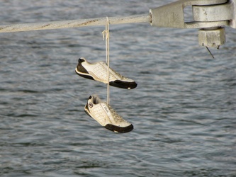 Shoes hanging from bridge cable [02]