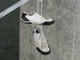 Shoes hanging from bridge cable [01]