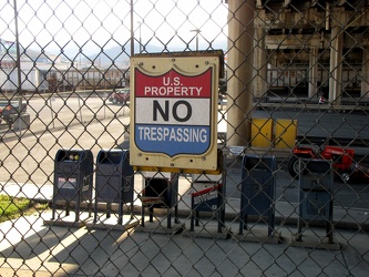 "No Trespassing" sign on post office fence