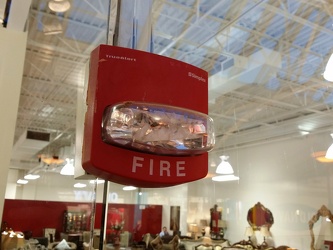 Fire alarm strobe mounted through a glass window