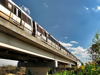 Green Line train crosses bridge over Paint Branch Trail