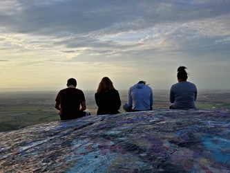 Four teens looking at their phones on High Rock