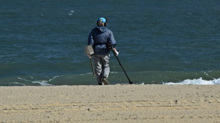 Person using metal detector on beach [01]