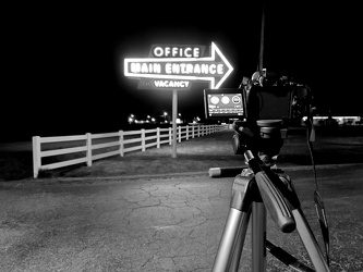 Camera photographing signs at Bel Alton Motel