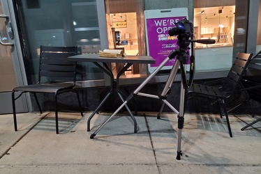 Camera on tripod photographing abandoned book