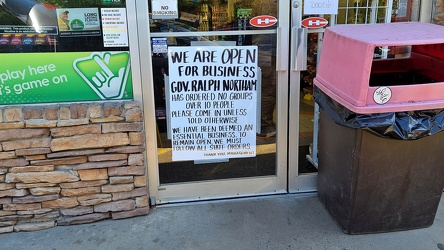 Lockdown-related sign on door of Exxon gas station