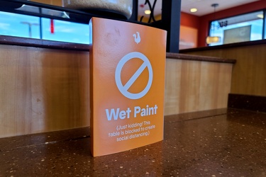 Social distancing sign at Popeye's