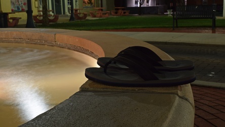 Flip flops on the edge of a fountain