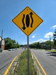 Sign indicating that traffic moves around the median