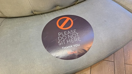 "Please do not sit here" sticker