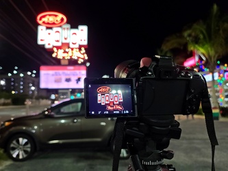 Photographing the sign for ABC Liquor