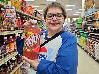 Elyse holds a bottle of Faygo soda