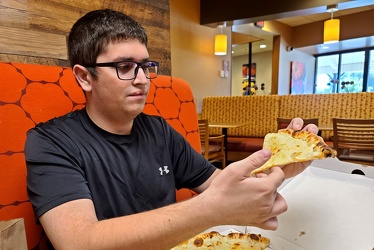 Aaron Stone holds a slice of Pizza [01]