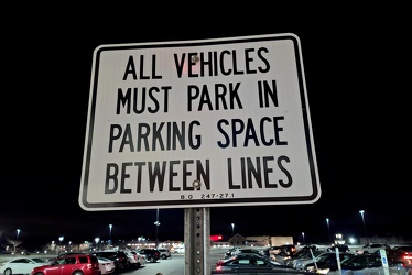 "ALL VEHICLES MUST PARK IN PARKING SPACE BETWEEN LINES"