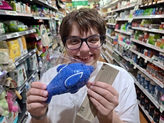 Elyse holds a dolphin scrubber