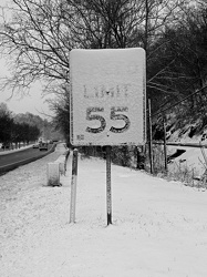 Snow-covered speed limit sign on US 250