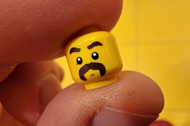 Lego minifigure head with big mustache and eyebrows