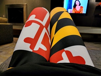 Striking the "beach knees" pose wearing my Maryland flag leggings