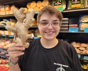 Elyse holds up a large ginger root