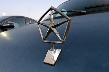 Pentastar hood ornament on a Dodge Caravan