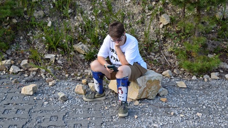 Elyse sits on a rock